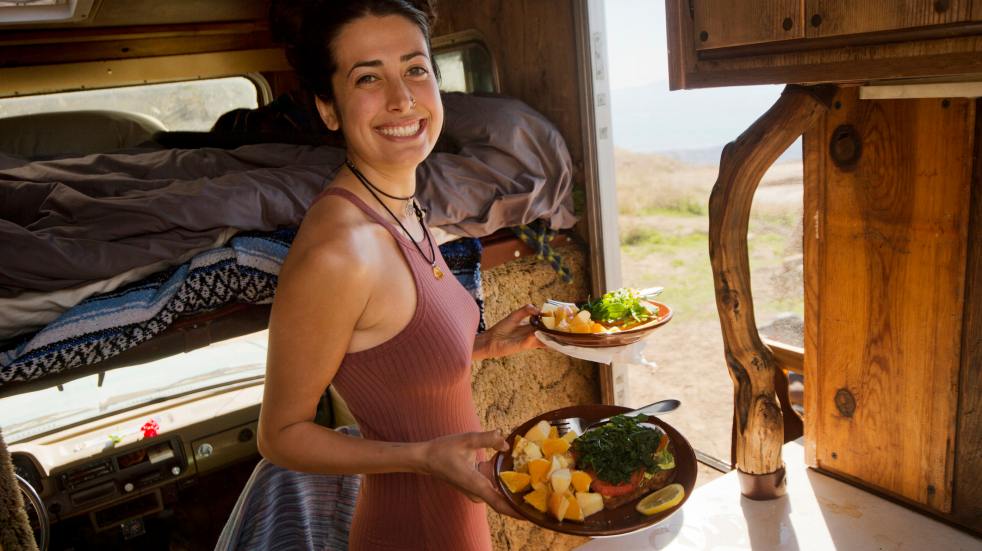 Woman plates of food motorhome